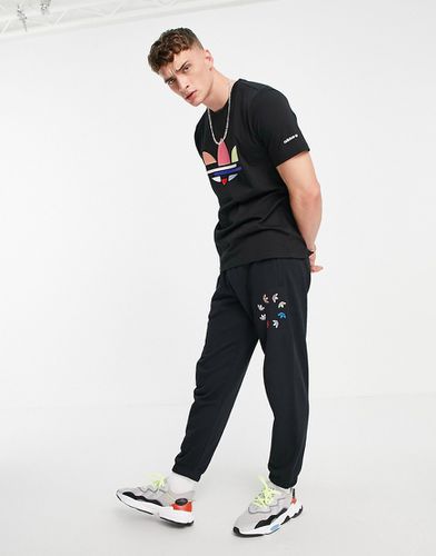 Pantalon de jogging à logo trèfle effet brisures - Adidas Originals - Modalova