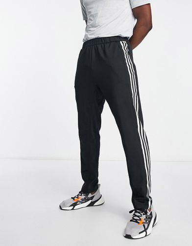 Pantalon de jogging noir coupe slim avec logo blanc floqué au niveau du  genoux gauche ADIDAS PERFORMANCE - CCV Mode