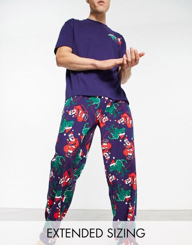 Ensemble de pyjama avec t-shirt et pantalon à imprimé dinosaure de Noël - Asos Design - Modalova