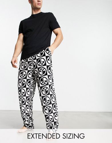 Ensemble de pyjama avec t-shirt et pantalon imprimé en polaire - Asos Design - Modalova