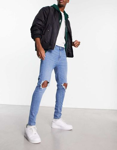 Jean seconde peau en tissu power stretch à genou déchiré - délavé classique - Asos Design - Modalova