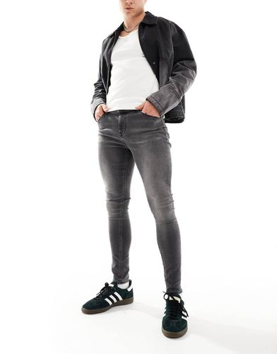 Jean seconde peau en tissu power stretch - Noir délavé - Asos Design - Modalova