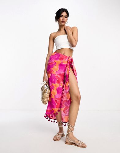 Jupe mi-longue style paréo à pampilles et motif fleuri flouté de couleurs vives - Asos Design - Modalova