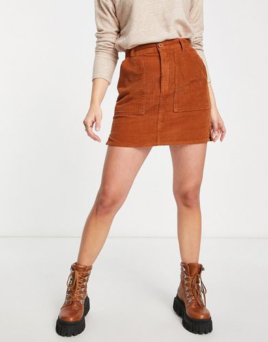 Mini-jupe en velours côtelé à poches plaquées - Rouille - Asos Design - Modalova