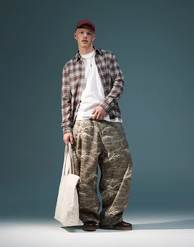 Pantalon bouffant oversize à imprimé camouflage - Asos Design - Modalova