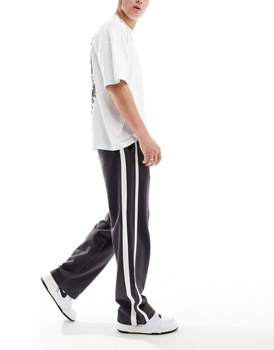 Pantalon de jogging ample à bandes latérales - Asos Design - Modalova