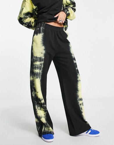 Pantalon de jogging oversize avec motif tie-dye sur le côté - et fluo - Asos Design - Modalova