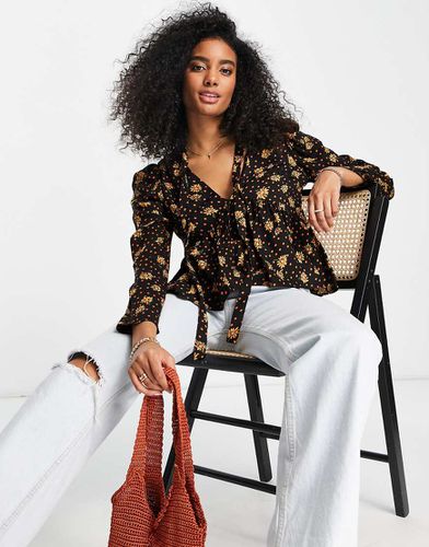 Top manches longues à fleurs avec col en V avec liens noués et ourlet à basque - Orange - Asos Design - Modalova