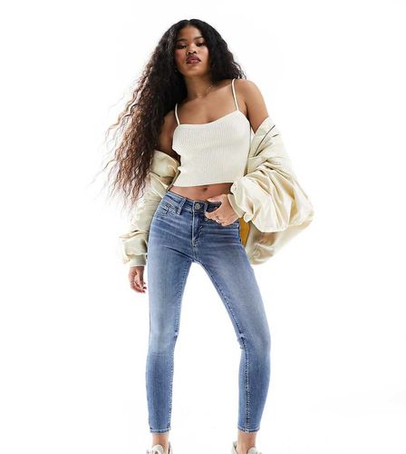 Jean skinny à taille mi-haute - moyen délavé - River Island Petite - Modalova