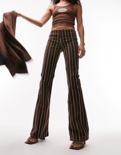 Pantalon évasé taille basse en velours côtelé avec imprimé à rayures - Chocolat - Topshop - Modalova