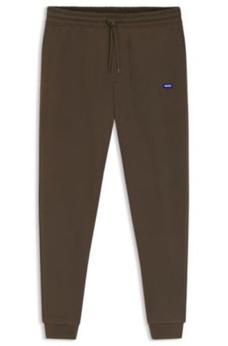 Bas de survêtement en molleton de coton avec patch logo - HUGO - Modalova