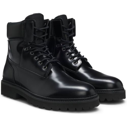 Bottines en cuir à bracelet matelassé et semelle crantée - HUGO - Modalova