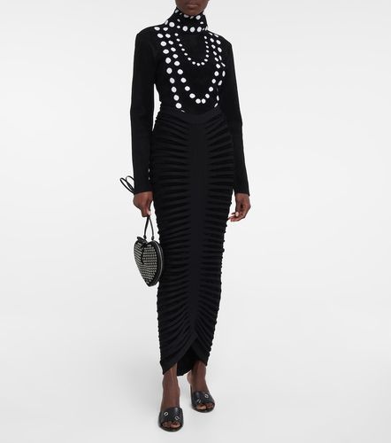 Alaïa Mules Œillets en cuir à ornements - Alaia - Modalova